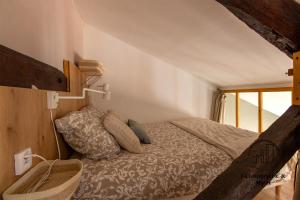 a bedroom with a bed and a window at The Nest, parking, centre, vue sur la Cathédrale in Albi
