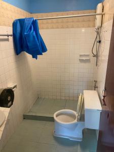 a bathroom with a blue toilet and a sink at Riviera Beach in Pattaya +28 photos