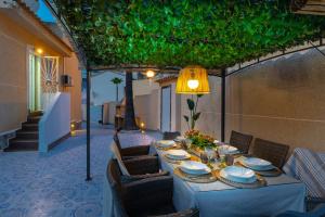a table with chairs and a lamp on a patio at The Big Chill by Fidalsa in Ciudad Quesada