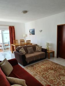 a living room with a couch and a table at Casa Marc in Carvoeiro