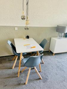 a white table and chairs in a room at Strandhafer in Wendtorf