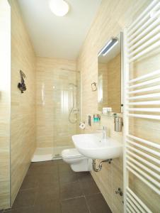 a bathroom with a sink and a toilet and a shower at SkyLux Apartments by Irundo in Zagreb