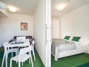 um quarto com uma cama e uma secretária com um computador portátil em SkyLux Apartments by Irundo em Zagreb