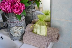 a bathroom sink with a vase of flowers and a mirror at La Casa di Betty in Lido di Ostia +34 photos