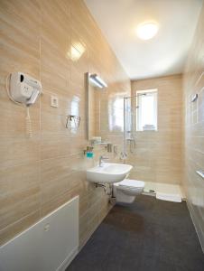 a bathroom with a sink and a toilet and a shower at SkyLux Apartments by Irundo in Zagreb