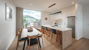 a kitchen and dining room with a table and chairs at Beautiful urban apartment 3 in Nelson