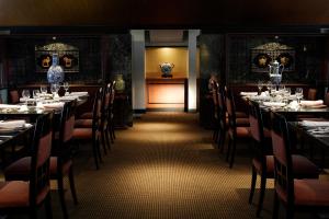 a dining room with tables and chairs and skulls on the wall at RIHGA Royal Hotel Osaka in Osaka