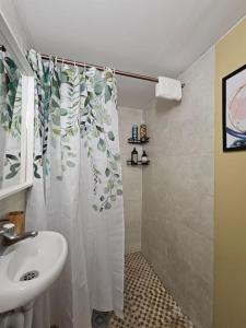 a bathroom with a sink and a shower curtain at Fulham 2 bedroom apartment in London