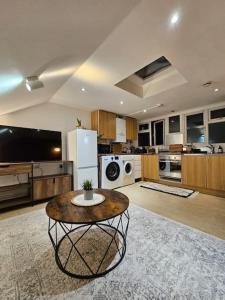 a large kitchen with a table in the middle of it at Fulham 2 bedroom apartment in London