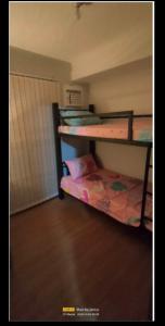 a room with two bunk beds and a bed at Pine Suites Tagaytay @ RoseAna Staycation in Tagaytay