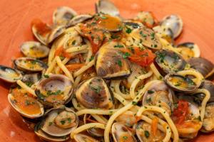 a plate of pasta with shrimp and seafood at La Terra Dei Sogni Country Hotel in Fiumefreddo di Sicilia