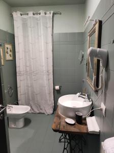 a bathroom with a sink and a toilet and a shower at B & B Casolara in San Giovanni +41 photos