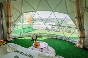 a room with a large window with a green floor at Bangmara Hill in Takua Pa