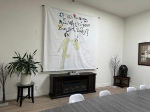 a room with a table and a banner on the wall at The Place in Las Vegas
