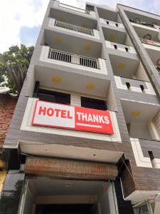 a hotel thanks sign on the side of a building at Hotel Thanks in New Delhi