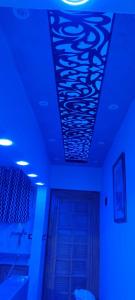 a room with blue lights on the ceiling and a door at كبائن النصر المعمورة الشاطىء 7 in Alexandria