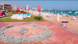 a view of the beach with chairs and tables at كبائن النصر المعمورة الشاطىء 7 in Alexandria