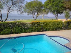 a swimming pool with a view of the ocean at Pecanwood villa on Hartbeespoort Dam in Hartbeespoort