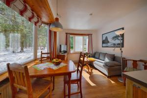 a living room with a table and a couch at Ferienresort Damerow in Ostseebad Koserow