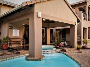 a swimming pool in a courtyard with a building at The Orion in Middelburg