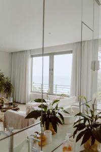 a bedroom with a large mirror and plants in it at Maison De Plage in Umdloti