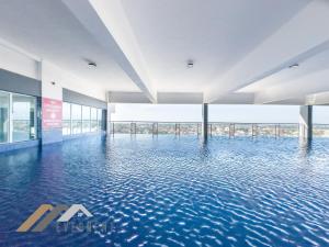 a swimming pool in a building with water at Stirling Suites by Evernent in Miri