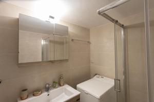 a bathroom with a toilet and a sink and a shower at Glyfada downtown in Athens