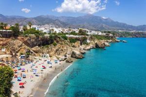 grupa ludzi na plaży w wodzie w obiekcie Nerja centro, playa carabeo w mieście Nerja +29 zdjęć