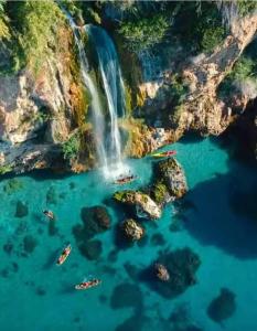 an aerial view of a waterfall over a body of water at Nerja centro, playa carabeo in Nerja