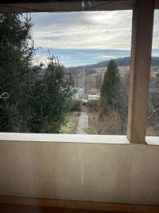a window of a house with a view of a road at Casa Iuliana in Valcea