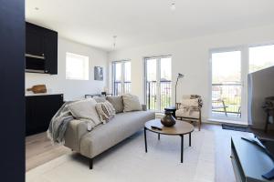 a living room with a couch and a table at The Wembley Park Sanctuary - Stunning 2BDR Flat with Balcony in London