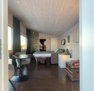 a room with a bed and a table in it at Badstue ved elven i Varangerbotn in Varangerbotn