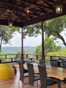 a table and chairs on a deck with a view at Oasis On Lily Northcliff in Johannesburg