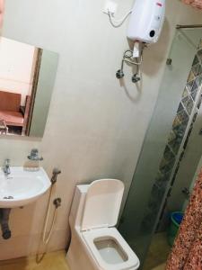 a bathroom with a toilet and a sink at The merit resort in Arpora