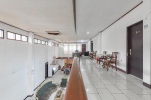 a large room with tables and chairs in it at RedDoorz near Taman Kota Lapang Merdeka Sukabumi in Sukabumi
