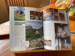 un libro aperto con una foto di un resort di Turtle Bay Eco Luxe Hua Hin a Khao Tao