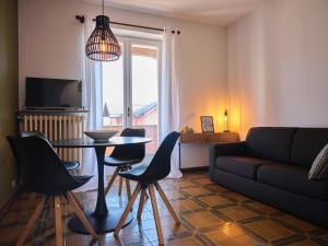 a living room with a couch and a table and chairs at Appartamento Filippo in Baveno