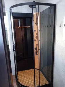 a shower with a glass door in a room at Domek u Anitki i Nikosia in Jeleśnia