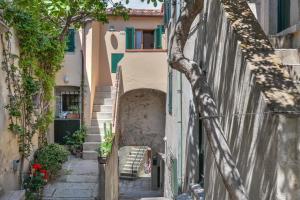 an alley with stairs and a house in the background at Casa Arancio in SantʼIlario in Campo