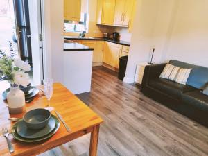 a kitchen and a living room with a table at LARGE 3 BEDROOM HOME, 3 BATHROOMS, FREE PARKING, FAST WIFI in Belfast