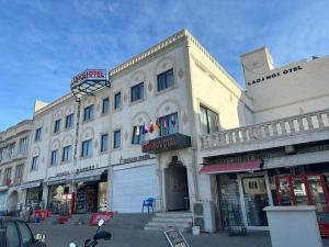 a large building on a city street with shops at MİDYAT LADİNOS OTEL in Midyat