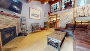 a living room with a couch and a fireplace at Summit #92 condo in Mammoth Lakes