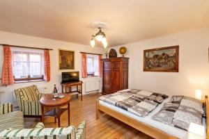 a bedroom with a bed and a table and chairs at Pension Nostalgie in Český Krumlov