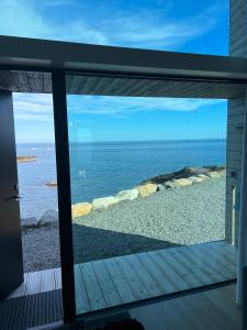 a view of the ocean from a house window at High end sea cabins at Å in Lofoten in Moskenes