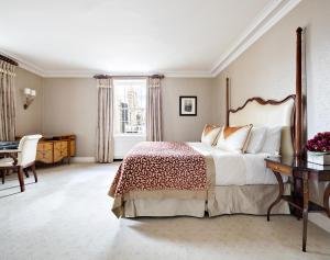 a bedroom with a large bed and a desk at The Pierre, A Taj Hotel, New York in New York