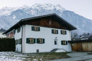 a large white house with mountains in the background at Chalet 1593 in Vandans