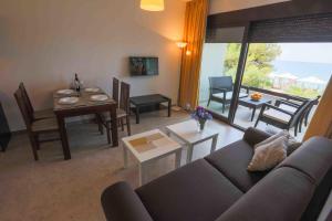 a living room with a couch and a table at Apartments Kuce Lekovica Beach & snack bar- Bistro in Bar