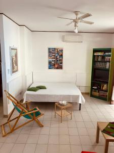 a bedroom with a bed and a chair at Casa Praiola in Terrasini