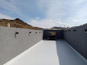 a room with concrete walls and a ceiling at Dorm Story For Hotel Apartment in Taif