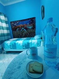 a table with a bottle of water and a piece of cake at Dar Hkaïem in Hammam Sousse